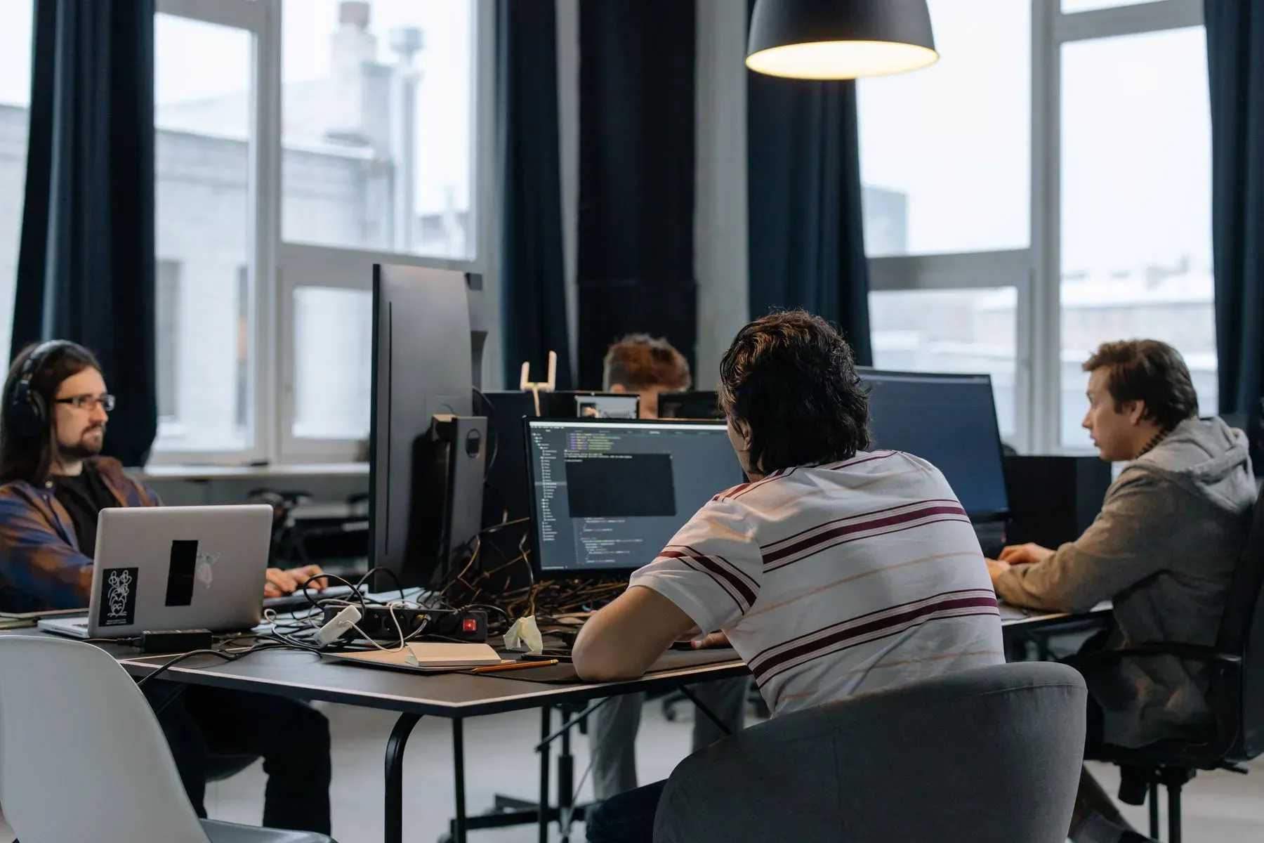 Team working focused on several screens